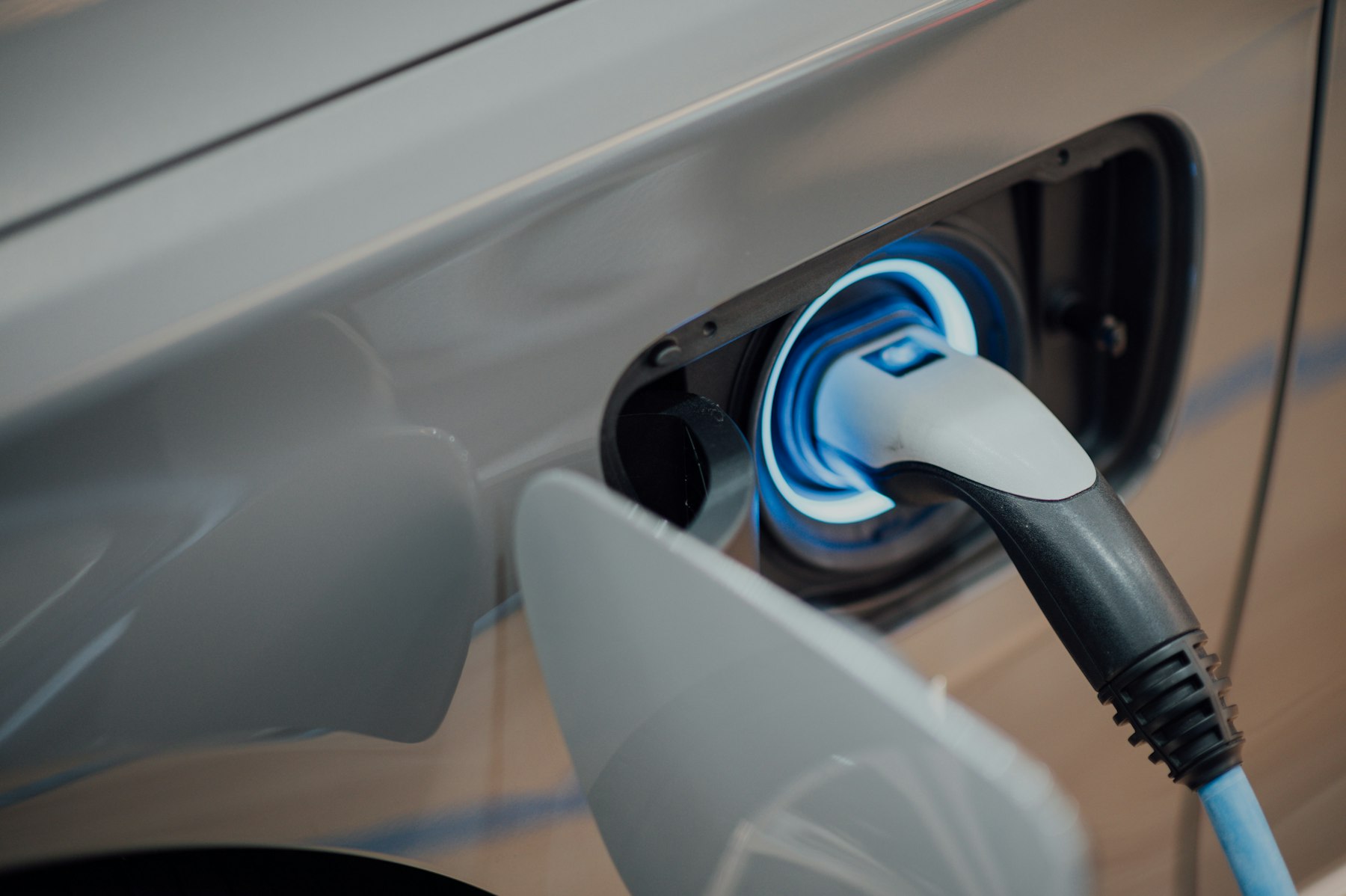 Electric vehicle plugged into a home wall charger